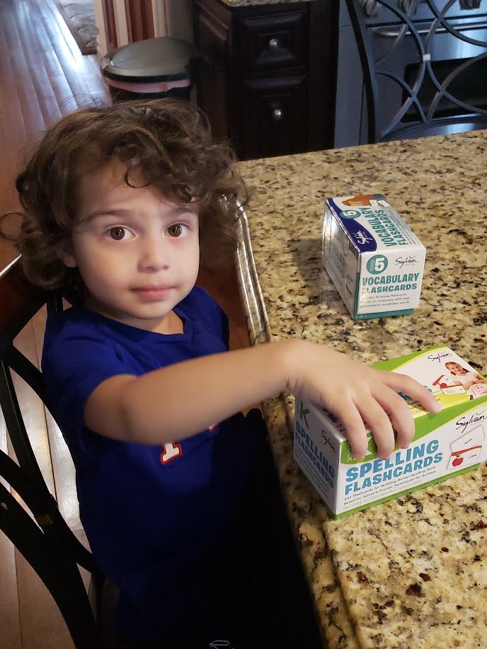 Ares exploring vocabulary and spelling flashcards as a young child